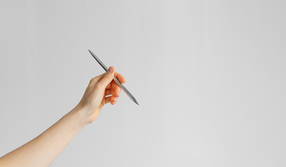 hand holding a pen on the white background