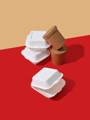 Takeaway food packaging: boxes and containers on colorful background with text space. Minimalistic concept