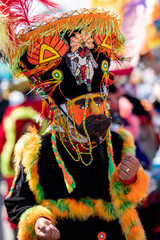 A person in a chinelo costume dancing moving their hands in a carnival in the State of Mexico