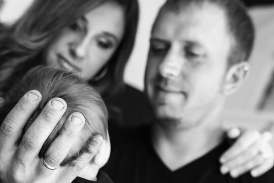 A Husband And Wife Hold And Admire Their Infant Son; Oregon, United States Of America