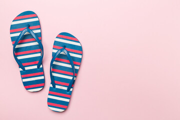 Bright flip flops on color background, top view