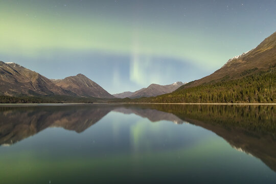 Green Aurora Borealis Dances Over The Kenai Mountains, Upper Trail Lake Reflections The Skies In The Foreground, Kenai Peninsula, Moose Pass, South-Central Alaska; Alaska, United States Of America