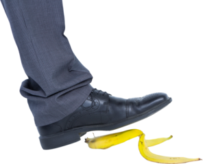 Businessman about to step on banana peel