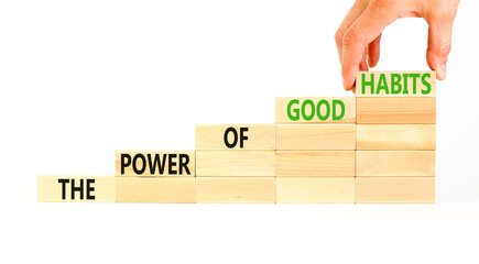 The power of good habits symbol. Concept words The power of good habits on wooden block. Beautiful white table white background. Businessman hand. Business the power of good habits concept. Copy space