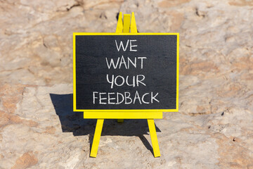 Support and we want your feedback symbol. Concept words We want your feedback on black chalk blackboard on a beautiful stone background. Business, support we want your feedback concept.