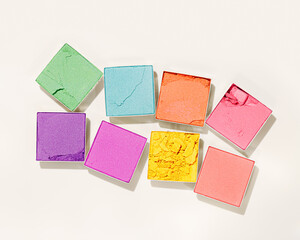 Set colors swatches powder eyes, close up cosmetic texture product for makeup on beige background. Colorful eyeshadow palette, beauty branding, merchandise concept, pastel color pattern