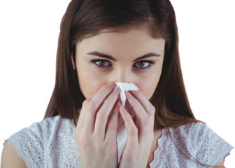 Portrait of sick woman blowing nose