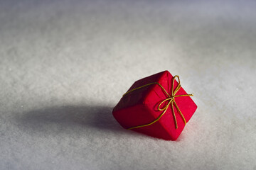 Red Christmas present in the snow; St. Albert, Alberta, Canada