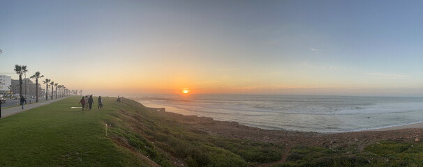 Morocco, Africa: panoramic view at sunset of Rabat Corniche, the city seafront overlooking golden sandy beaches, with perfect waves for surfers, playgrounds and amenities © Naeblys