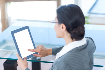 Fototapeta na wymiar Businesswoman using digital tablet in office
