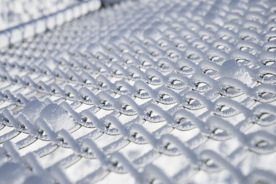 A chain link fence covered in snow and frost; Minnesota, United States of America