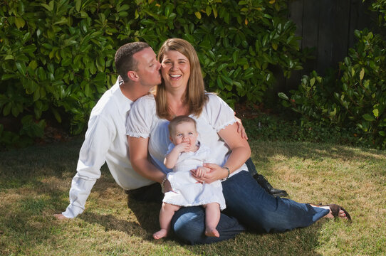 Portrait of a young couple with a baby on the grass; Moraga california united states of america