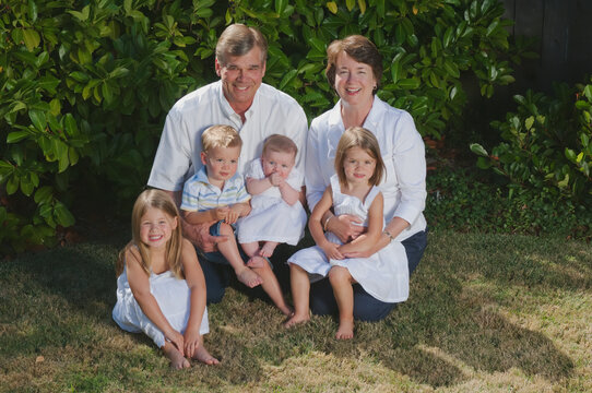 Portrait of grandparents with grandchildren on the grass; Moraga california united states of america