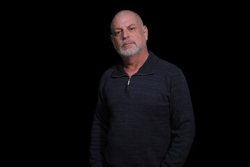 Fototapeta premium portrait of older bearded man pensive and watching isolated on black background