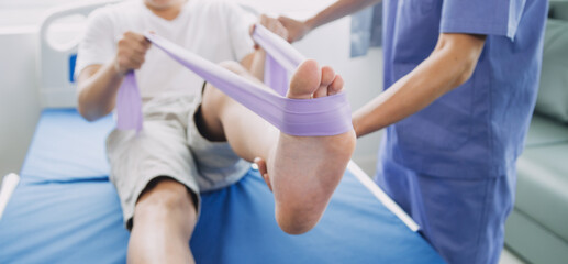 Doctor or Physiotherapist working examining treating injured arm of athlete male patient, stretching and exercise, Doing the Rehabilitation therapy pain in clinic.