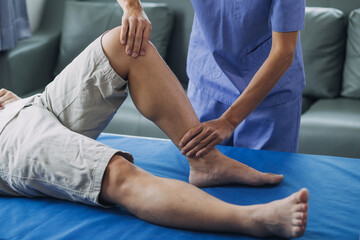 Fototapeta premium Doctor or Physiotherapist working examining treating injured arm of athlete male patient, stretching and exercise, Doing the Rehabilitation therapy pain in clinic.