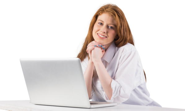 Pretty redhead working on laptop