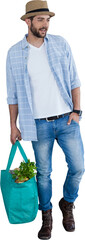 Full length of handsome model holding bag with vegetables