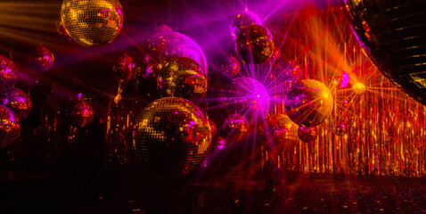 disco background with disco balls in purple and gold lighting