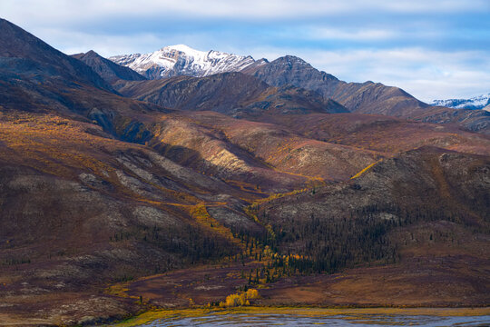Incredible mountains along the Dempster Highway create amazing landscapes while fall colors settle into the land; Dawson City, Yukon, Canada