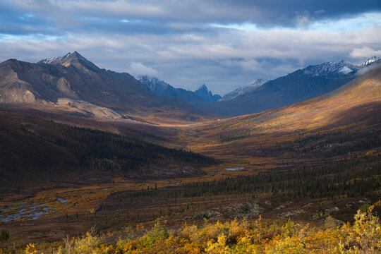 Incredible mountains along the Dempster Highway create amazing landscapes while fall colors settle into the land in Tombstone Territorial Park; Dawson City, Yukon, Canada