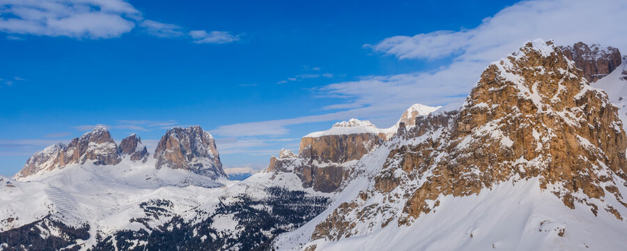 Overview of the snow covered mountain peaks of the Sella Group in Val di Fasso near the Canazei Ski Resort Town in the Trento District; Trentino-Alto Adige, Dolomites, Italy