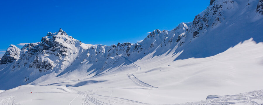 Snowy ski trails and mountain peaks of the Sella Group in Val di Fasso, Trentino Alto Adige, Italy
