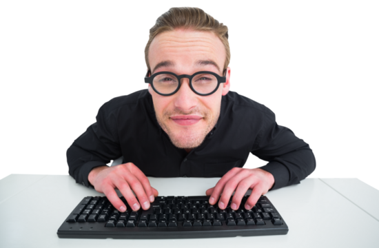 Smiling businessman typing on keyboard at desk - Powered by Adobe