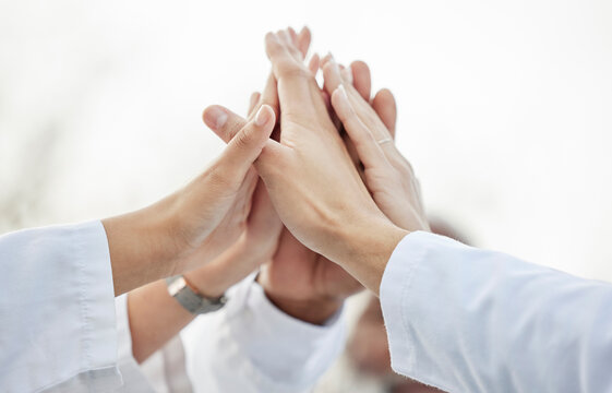 Hands, doctors and group high five in closeup for motivation, success or team building in hospital. Doctor, teamwork and hand gesture for solidarity, support or collaboration for healthcare in clinic