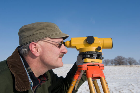 Man surveys farmland in winter near Dunbar in Nebraska, USA; Nebraska, United States of America