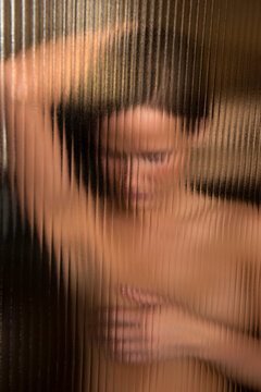 Young woman does a breast self-examination to check herself for breast cancer; Lincoln, Nebraska, United States of America