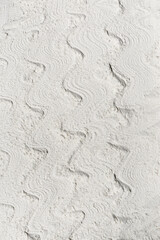 Soft white wavy textured background made with white flour. Creative pattern concept of sand on a beach.