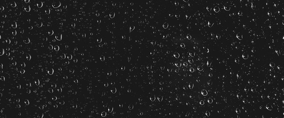 Atmospheric minimal grayscale backdrop with rain droplets on glass. Wet window with rainy drops and dirt spots closeup. Blurry minimalist monochrome background of dirty window glass with raindrops.