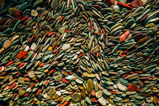 Colourful cobbles line the glacier-carved basin of St. Mary Lake, Glacier National Park, Montana, USA; Montana, United States of America