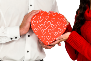 Couple holding heart shaped gift box