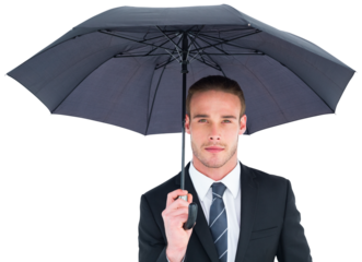 Unsmiling businessman sheltering under umbrella