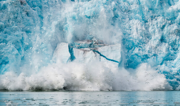 Ice from the Monacobreen Glacier crashes into the sea; Norway