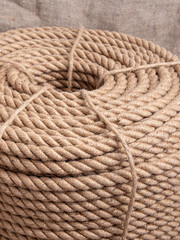 Fastening twine on canvas background. Jute rope closeup. Rope for wooden house construction