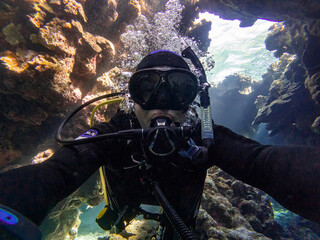 Diving in a coral canyon or cave in the red sea in egypt
