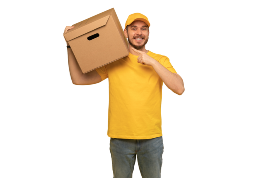 Portrait of excited delivery man in yellow uniform holding paper box isolated over transparent background