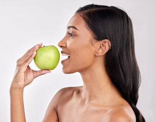Obraz na płótnie Canvas Woman, apple and face profile, health nutrition and fruit with healthy food and detox diet on studio background. Weight loss, organic and fresh produce with happy female mouth, wellness and lifestyle