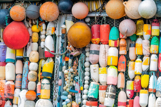 Close-up of colourful fishing buoys hanging in a row; Morro Bay, California, United States of America