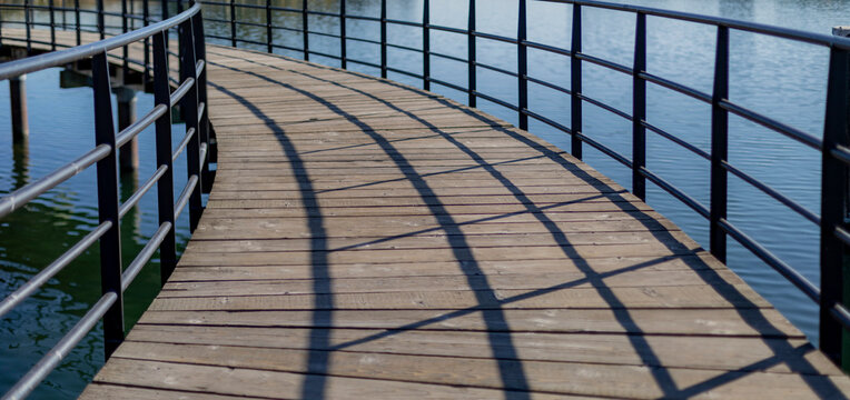 Wooden walking and iron railings over water; Victoria, British Columbia, Canada