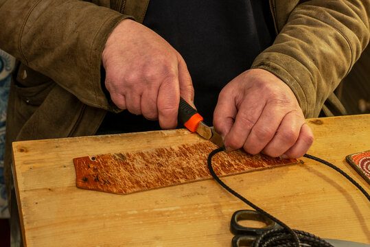 An artisan making a leather bracelet in Florence