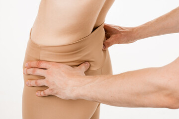 Examination of scoliotic deformity of the lumbar spine. Scoliosis is sideways curvature of the spine. Orthopedic traumatologist examines scoliosis of spine on white background.