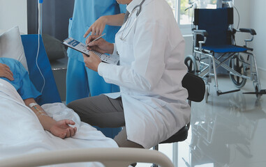 Women Asian doctors hold the patient hand and encourage and provide medical advice While checking...