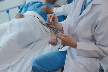 Women Asian doctors hold the patient hand and encourage and provide medical advice While checking the patient health in bed. Concept of Care and compassion, antenatal care, Threatened abortion