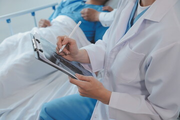 Women Asian doctors hold the patient hand and encourage and provide medical advice While checking...