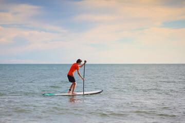 Man on stand up paddle. Water and beach sport