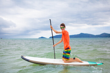 Man on stand up paddle. Water and beach sport